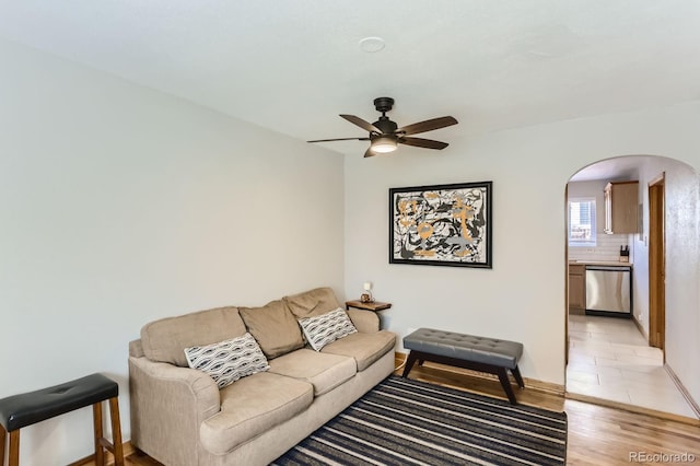 3061 W 18th Ave, Denver, CO 80204 - living room with arched walkways, a ceiling fan, light wood-style floors, and baseboards