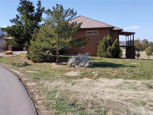 view of side of property featuring stucco siding