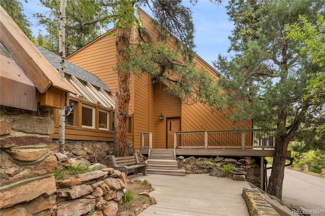 rear view of house featuring a wooden deck