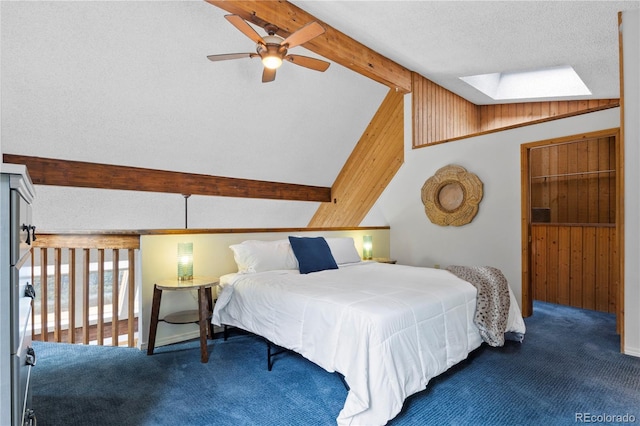 bedroom with carpet flooring, a textured ceiling, and lofted ceiling with skylight