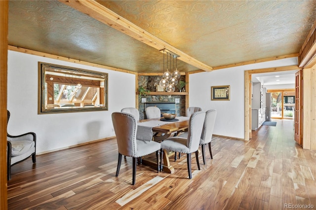 dining area featuring baseboards and wood finished floors