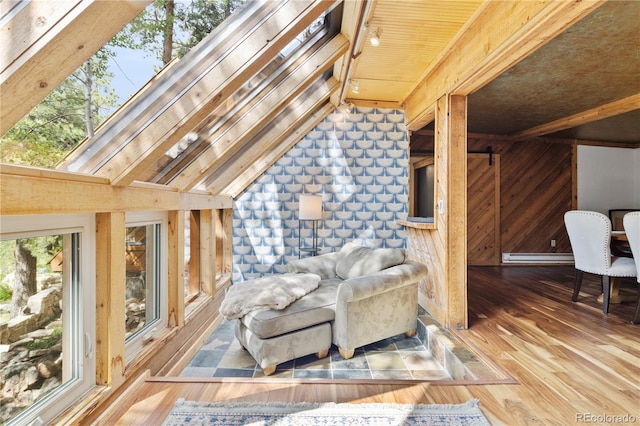 living area featuring a baseboard radiator, lofted ceiling with beams, wood finished floors, and wood walls