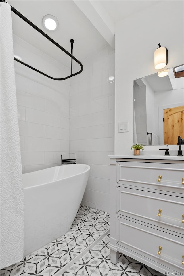 bathroom with a shower with curtain, vanity, tile patterned floors, and a tub to relax in