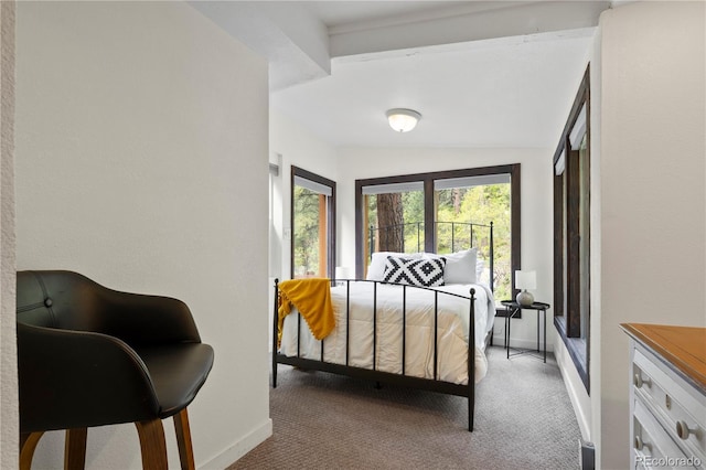 carpeted bedroom featuring baseboards and lofted ceiling