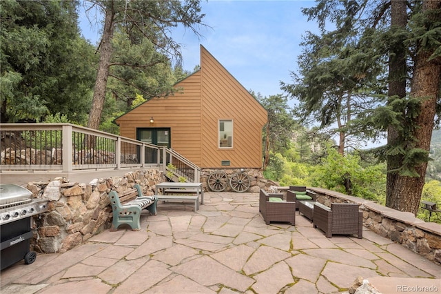 view of patio featuring an outdoor hangout area, a wooden deck, and a grill