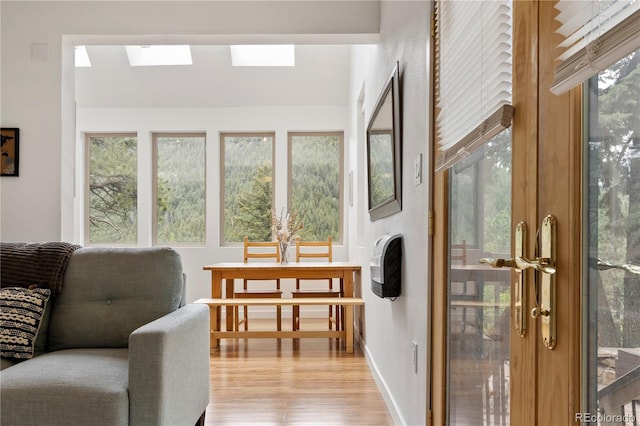 sunroom featuring a skylight and french doors
