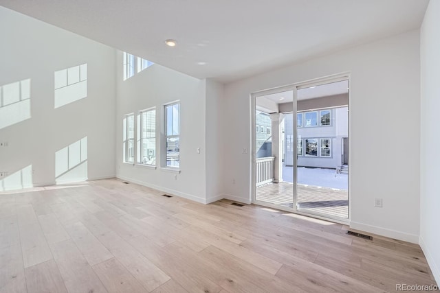 unfurnished room with light hardwood / wood-style flooring