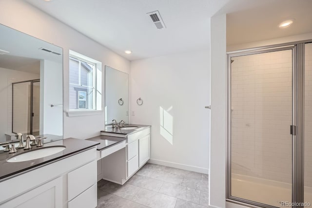 bathroom with tile patterned flooring, vanity, and a shower with shower door