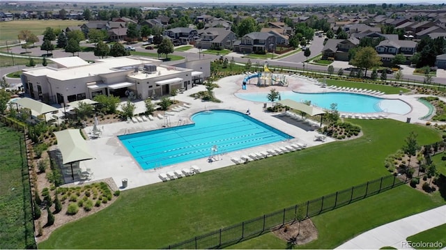 view of pool featuring a patio area and a yard