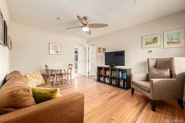 1800 Grove St, Denver, CO 80204 - living area with arched walkways, light wood finished floors, and a ceiling fan
