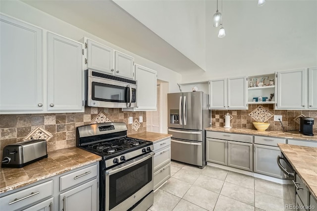 10064 Owens St, Broomfield, CO 80021 - kitchen with stainless steel appliances, open shelves, backsplash, light tile patterned flooring, and wood counters