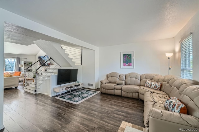 10064 Owens St, Broomfield, CO 80021 - living area featuring stairs, wood finished floors, plenty of natural light, a textured ceiling, and baseboards