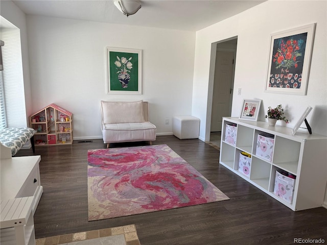 10064 Owens St, Broomfield, CO 80021 - sitting room with dark wood-style floors and baseboards