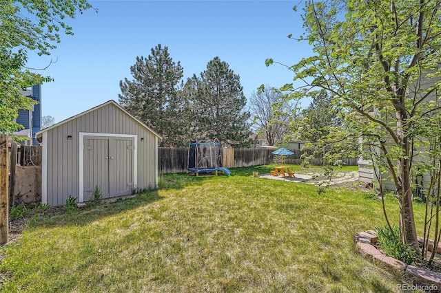 10064 Owens St, Broomfield, CO 80021 - view of yard with a storage shed, a trampoline, an outdoor structure, and a patio area
