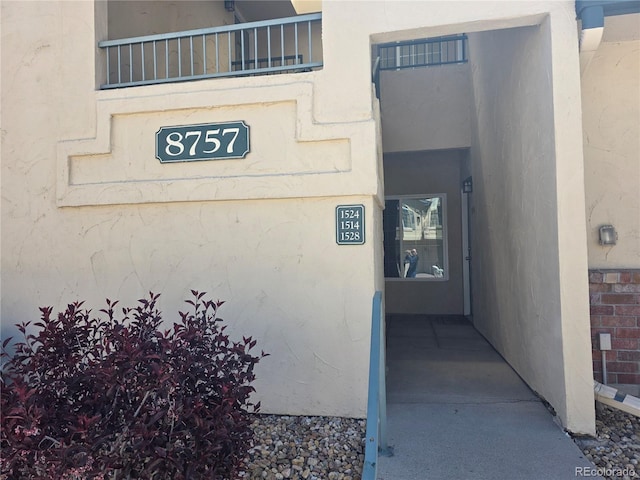 property entrance with stucco siding