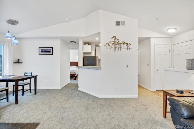 dining space with lofted ceiling, carpet flooring, and baseboards