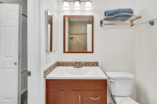 full bathroom with vanity, toilet, and a shower