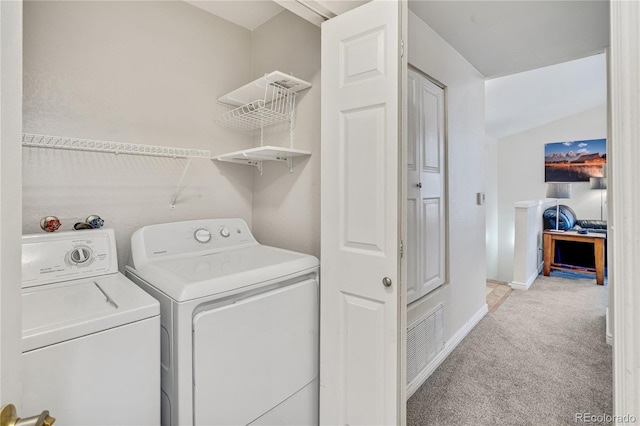 washroom with washing machine and clothes dryer, carpet flooring, and baseboards