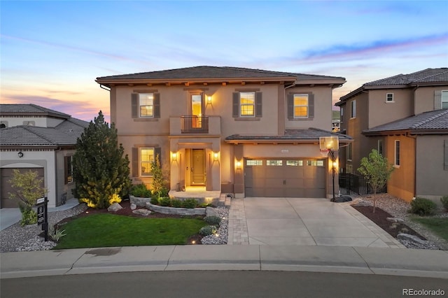 10601 Montecito Dr, Lone Tree, CO 80124 - mediterranean / spanish-style house featuring a balcony, stucco siding, an attached garage, and driveway
