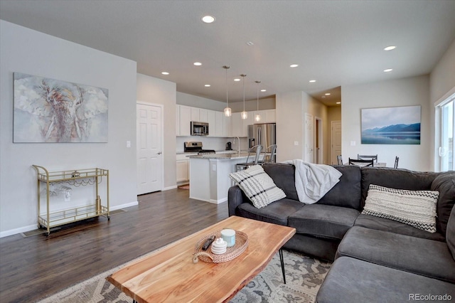 6612 N Ceylon St, Denver, CO 80249 - living room with dark wood finished floors, recessed lighting, and baseboards