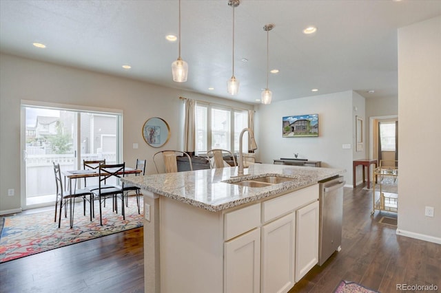 6612 N Ceylon St, Denver, CO 80249 - kitchen featuring a sink, dishwasher, dark wood finished floors, plenty of natural light, and recessed lighting