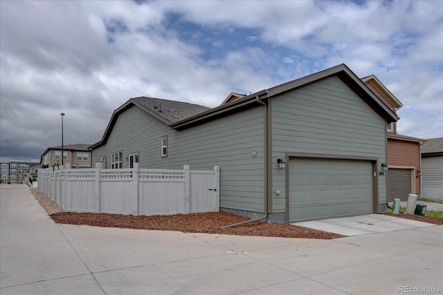 6612 N Ceylon St, Denver, CO 80249 - view of home's exterior featuring concrete driveway and an attached garage