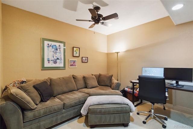 carpeted home office featuring a ceiling fan
