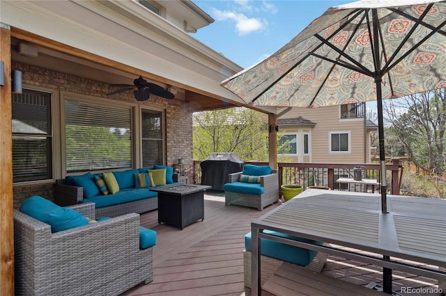 deck featuring an outdoor living space with a fire pit, ceiling fan, and outdoor dining area