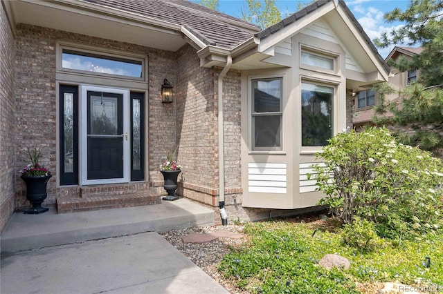 entrance to property with brick siding
