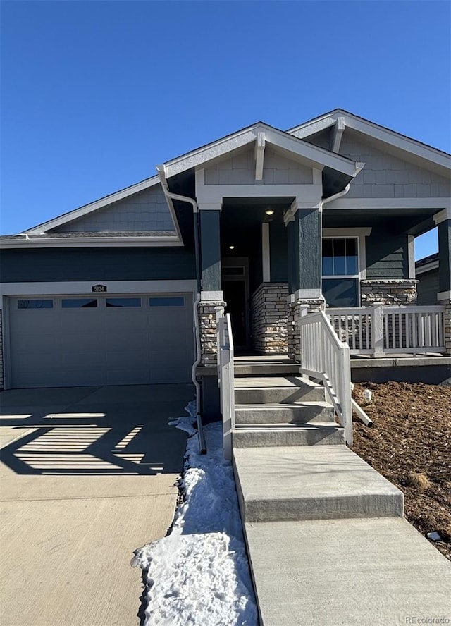 view of front of property with a porch and a garage