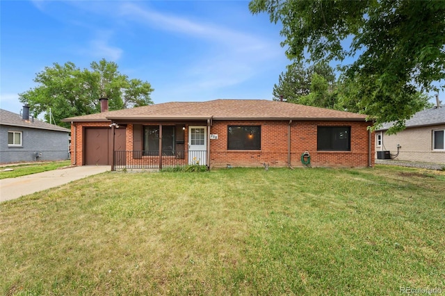 708 Revere St, Aurora, CO 80011 - ranch-style house with brick siding, concrete driveway, a garage, and a front lawn