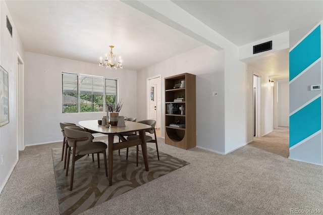 708 Revere St, Aurora, CO 80011 - carpeted dining room with a chandelier and baseboards
