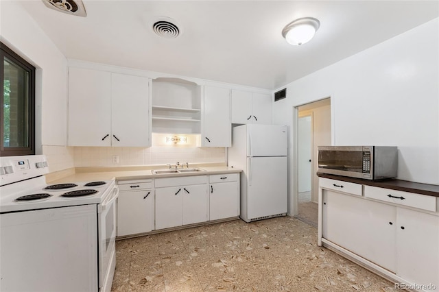 708 Revere St, Aurora, CO 80011 - kitchen featuring white appliances, open shelves, decorative backsplash, and white cabinetry