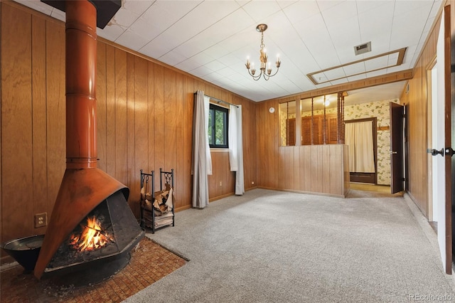 708 Revere St, Aurora, CO 80011 - sitting room featuring light colored carpet, a chandelier, and wood walls