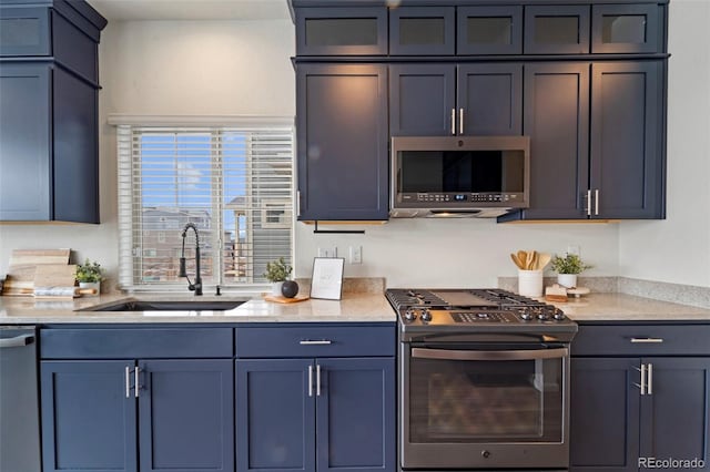 kitchen featuring light stone countertops, glass insert cabinets, stainless steel appliances, and a sink