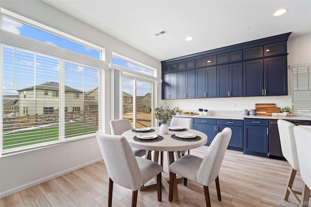 dining area with light wood-style floors, recessed lighting, and visible vents