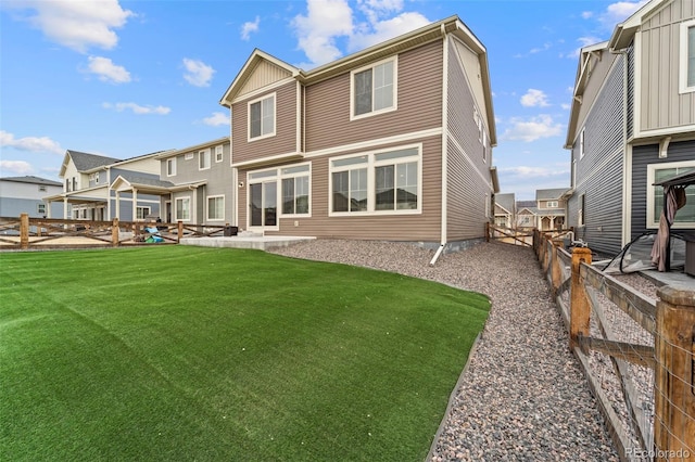 back of house with a patio area, a fenced backyard, and a lawn