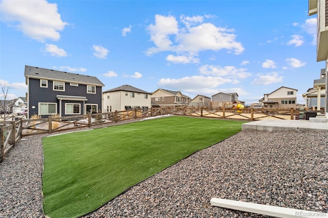 view of yard with a residential view, a patio area, and a fenced backyard