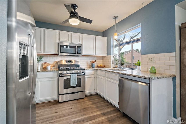 kitchen with white cabinets, stainless steel appliances, and a sink