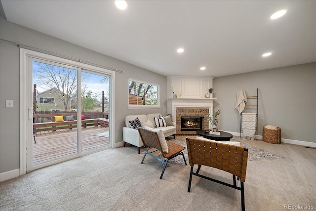 living room featuring recessed lighting, baseboards, light colored carpet, and a fireplace