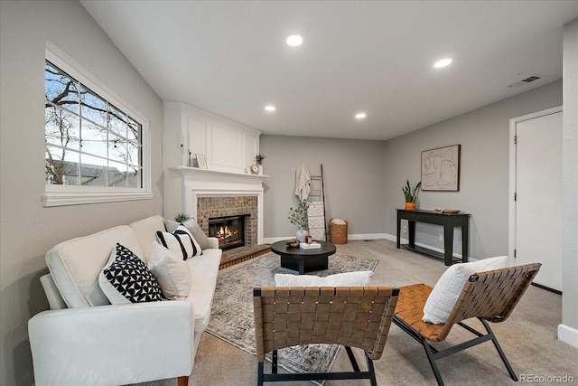 living area with recessed lighting, baseboards, visible vents, and a fireplace