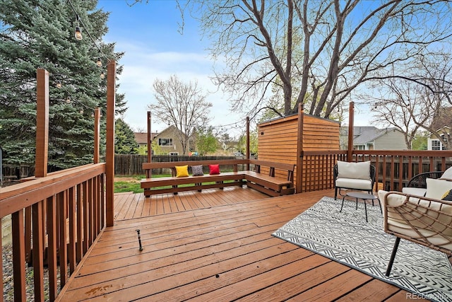 wooden terrace featuring a fenced backyard