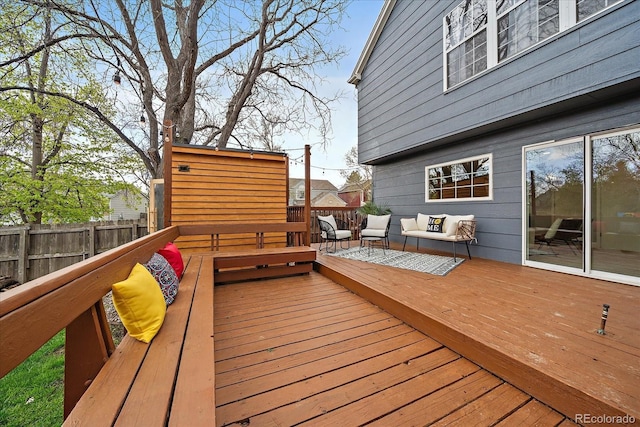 wooden terrace featuring a fenced backyard and outdoor lounge area