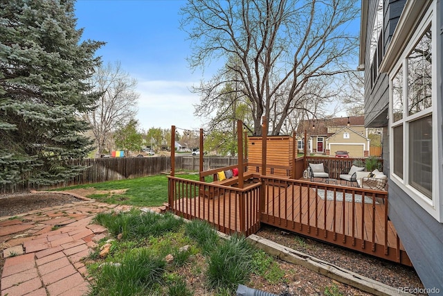deck with a fenced backyard and a yard