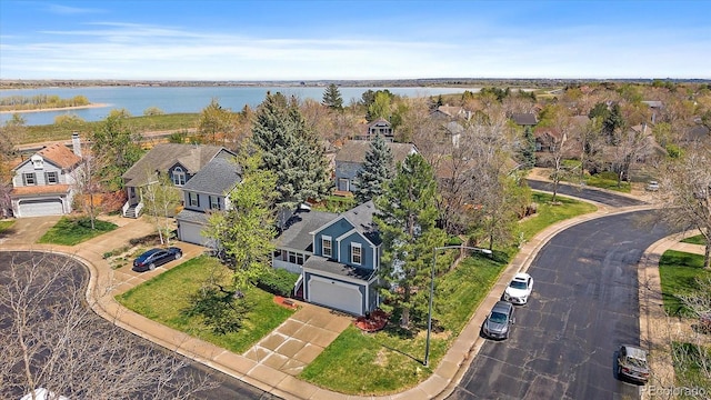 drone / aerial view featuring a water view and a residential view
