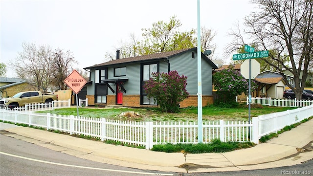 1528 Coronado Pkwy, Denver, CO 80229 - view of front of house featuring brick siding and a fenced front yard