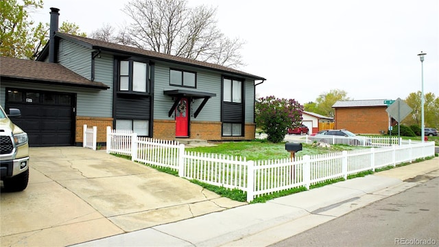 1528 Coronado Pkwy, Denver, CO 80229 - raised ranch featuring an attached garage, brick siding, a fenced front yard, and concrete driveway