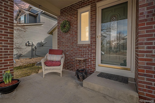 view of exterior entry with brick siding