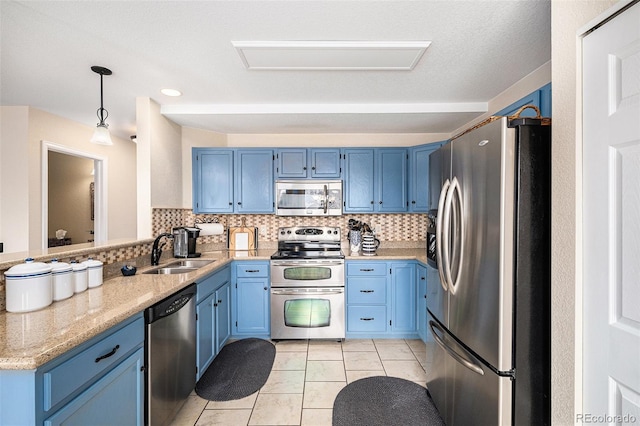 kitchen with blue cabinets, a peninsula, stainless steel appliances, and a sink