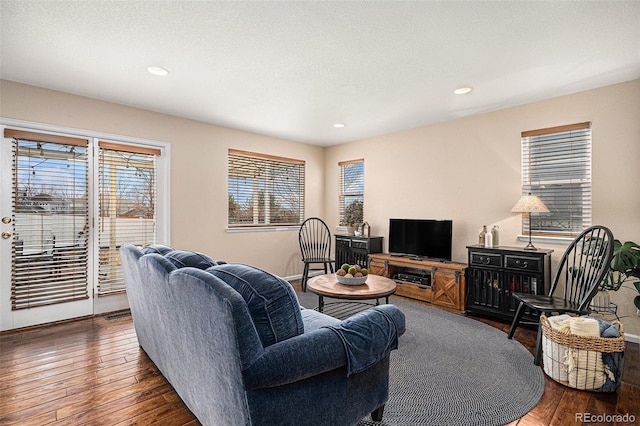 living room featuring a textured ceiling, hardwood / wood-style floors, and recessed lighting